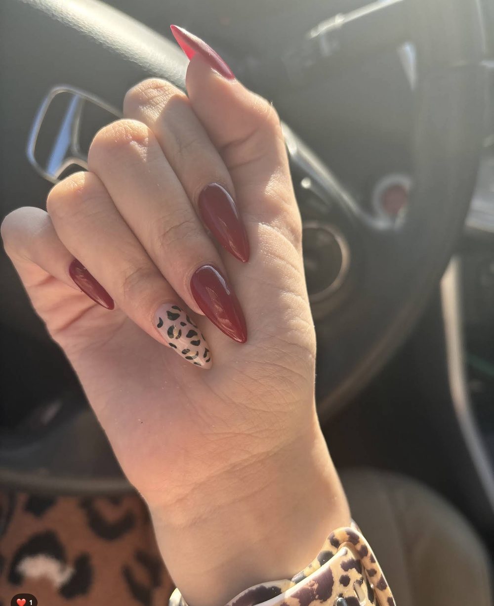 Deep red almond nails shared by a Pedi N Nails London guest